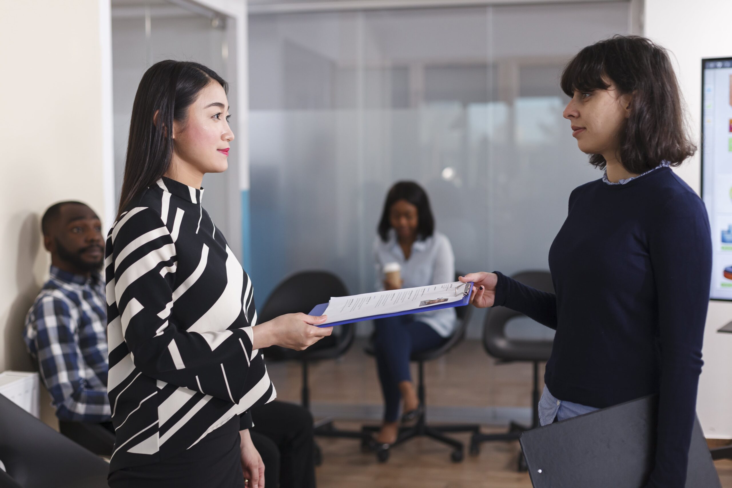 candidate handing over resume to recruiter